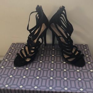 Arden B Black heels with gold zipper.